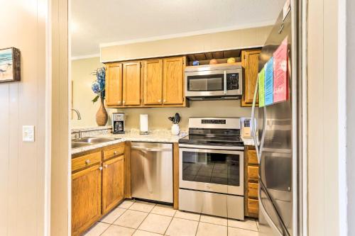 a kitchen with wooden cabinets and stainless steel appliances at Ocean Views and 3 Pools Hilton Head Resort Condo in Hilton Head Island