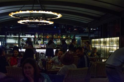 a group of people sitting at a bar in a restaurant at Casa 1810 Hotel Boutique in San Miguel de Allende
