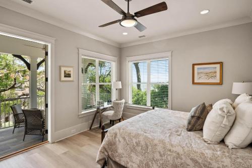 a bedroom with a bed with a ceiling fan at Viewpoint Oaks - 301 7th Street, Unit 101 in Saint Simons