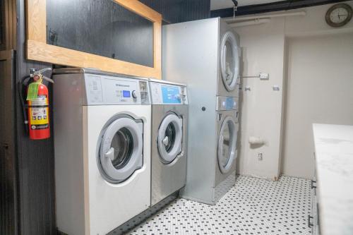 a laundry room with three washing machines in it at Amsterdam Hostel in San Francisco