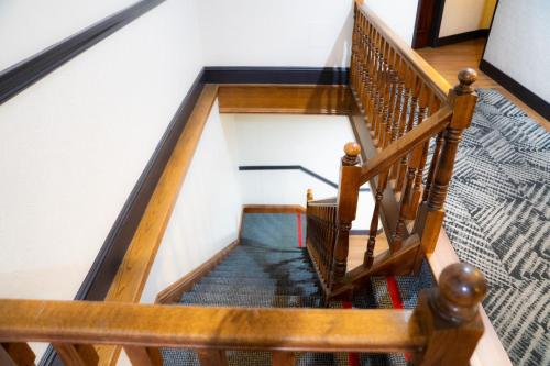 a winding staircase with wooden railings in a house at Amsterdam Hostel in San Francisco