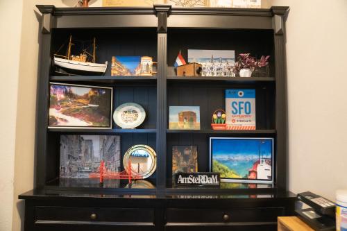 a black shelf with pictures on it at Amsterdam Hostel in San Francisco