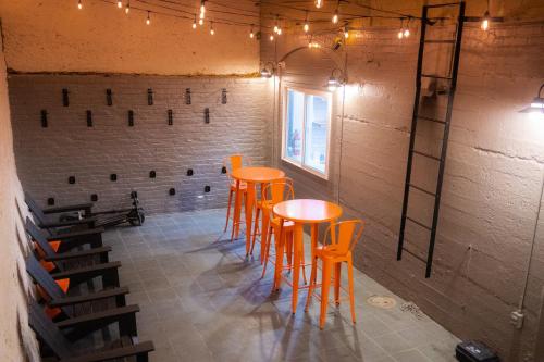 a room with orange stools and a wine cellar at Amsterdam Hostel in San Francisco
