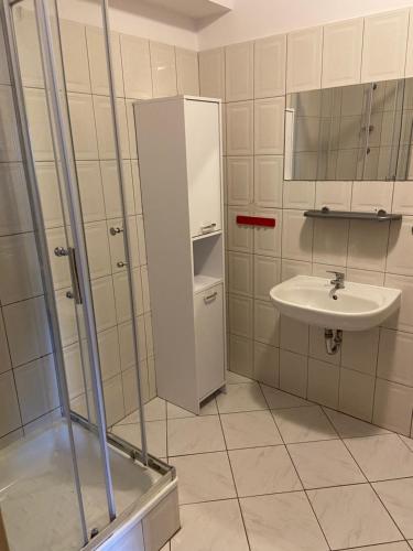 a bathroom with a sink and a toilet and a shower at Willa Marin in Karwia