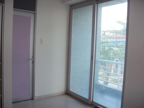 an empty room with a sliding glass door at Selva Suites in Iquitos