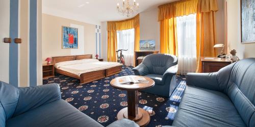 a living room with a couch and a bed at Brioni Boutique Hotel 4* in Ostrava