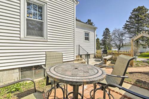 a patio with a table and chairs in front of a house at Modern Sturgeon Bay Home by Potawatomi State Park! in Sturgeon Bay
