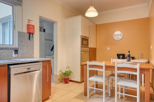 a kitchen with a table and chairs in a room at Lidia's Place, a Home in Madeira in Ponta do Sol