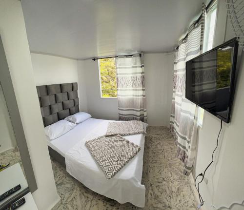 Ένα ή περισσότερα κρεβάτια σε δωμάτιο στο Hotel Mira Cruz Toro Valle