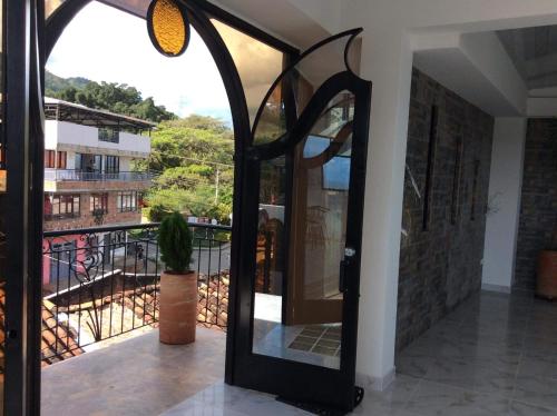 a glass door with a view of a balcony at Heinz B. in Santa Ana de los Caballeros