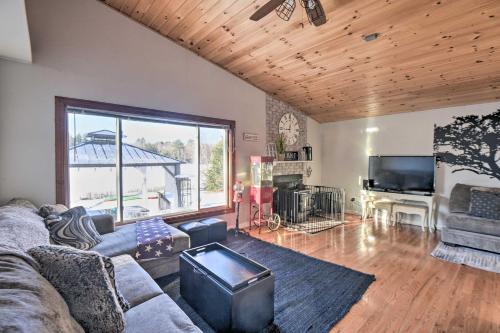 a living room with a couch and a tv at New Hampshire Home with Private Beach, Dock and Rafts! in Barnstead