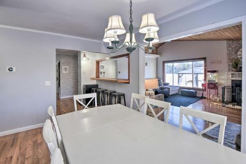 a dining room and living room with a white table and chairs at New Hampshire Home with Private Beach, Dock and Rafts! in Barnstead