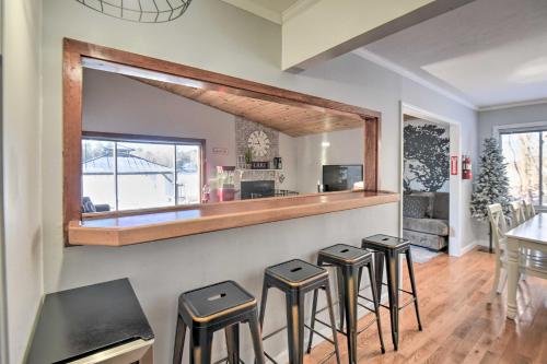 a group of stools in a room with a bar at New Hampshire Home with Private Beach, Dock and Rafts! in Barnstead