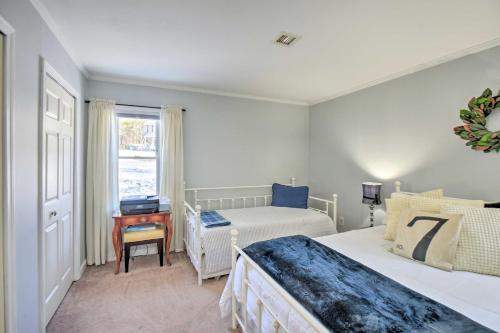 a bedroom with two beds and a desk and a window at New Hampshire Home with Private Beach, Dock and Rafts! in Barnstead
