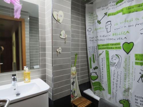 a bathroom with a sink and a shower curtain at Disfruta de LaCerdanya en "Casa Egipcia" in La Molina