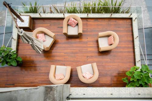 a building with chairs and plants on a wall at Aruá Pousada Boutique in Torres