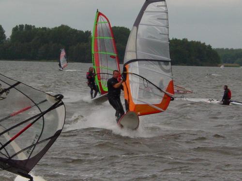 a group of people windsurfing in the water at B&B Veluwemeerpension in Nunspeet