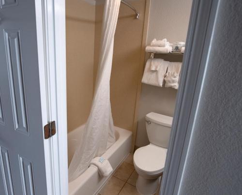 a bathroom with a toilet and a shower curtain at Aqua Beach Inn in Myrtle Beach