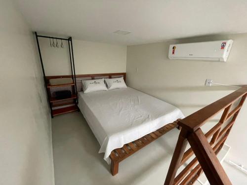 a small bedroom with a bed and a staircase at Matzzon Apart Hotel in João Câmara