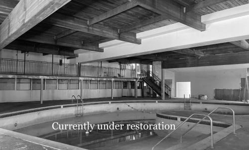 a swimming pool in a building with the words currently under restoration at The Historic Brookdale Lodge, Santa Cruz Mountains in Brookdale