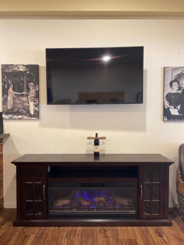 a living room with a tv and a fire place at The Historic Brookdale Lodge, Santa Cruz Mountains in Brookdale
