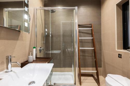 y baño con ducha, lavabo y aseo. en Spacious 3BR APT in Prime Location of St Julians by 360 Estates, en Tal-Għoqod