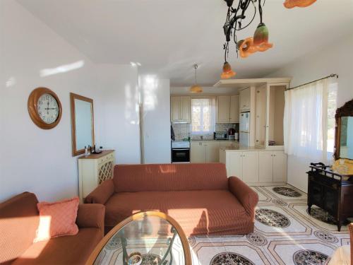 a living room with a couch and a kitchen at Lakena Sunset View Villa in Menetaí