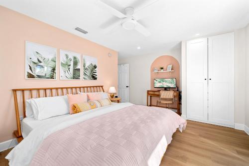 a bedroom with a bed and a ceiling fan at Luxury Villa 3 Blocks from the Beach with Hot Tub a Fire Pit and Outdoor Oasis in Cape Canaveral