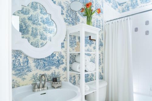 a bathroom with blue and white wallpaper and a sink at A Williamsburg White House Inn in Williamsburg
