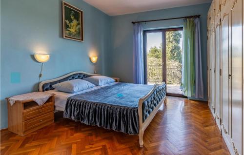 a bedroom with a bed and a large window at Gorgeous Apartment In Medulin With Kitchen in Medulin