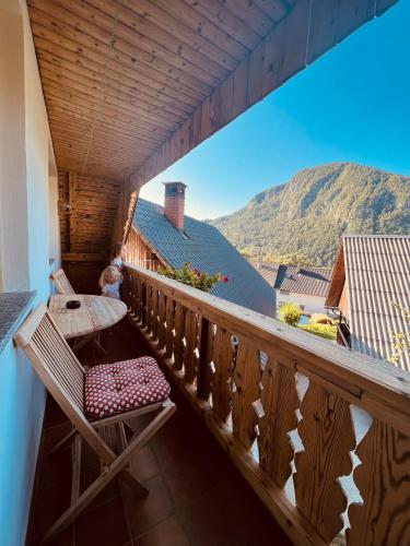 a balcony with a table and a chair on it at Apartmaji Katrnjek in Bohinj
