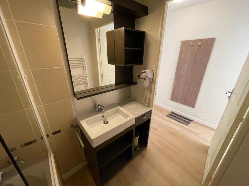 a bathroom with a sink and a mirror at Appartement Valberg in Valberg