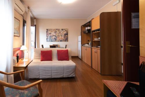 a bedroom with a bed with two red pillows on it at Residence La Fenice in Padova