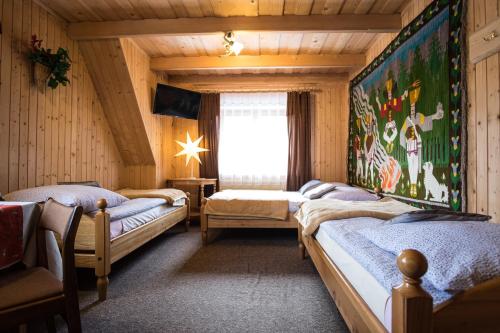 a bedroom with two beds and a window at Zakopane - Króle 16 in Zakopane