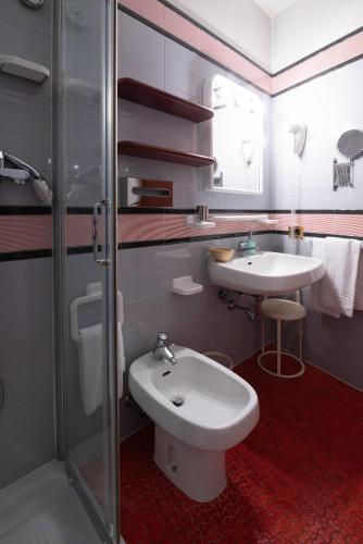a bathroom with a sink and a toilet and a shower at Residence La Fenice in Padova