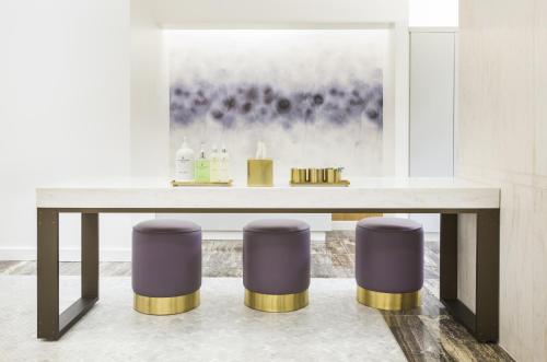 a table with two purple stools in a room at Four Seasons Hotel Houston in Houston
