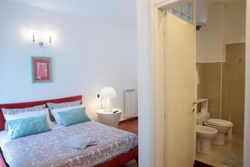 a bedroom with a bed and a bathroom with a toilet at SAVOIA & CAVOUR _ Premium Signature _ in Bari