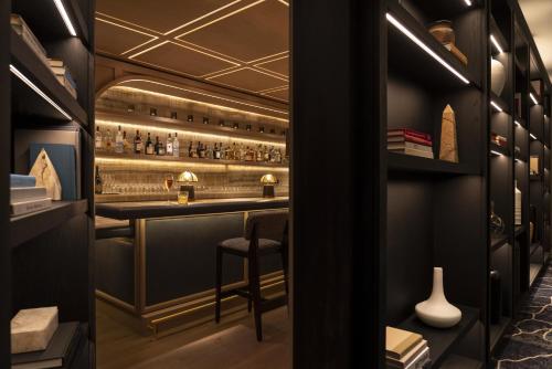 a bar with a stool in a room at Four Seasons Hotel Houston in Houston