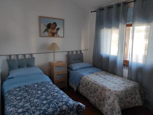a bedroom with two beds and a window at Sea Breeze in Viareggio