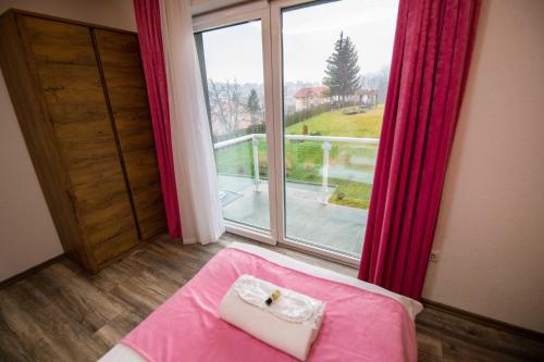 サラエボにあるVilla Panoramaのベッド1台と大きな窓が備わる客室です。
