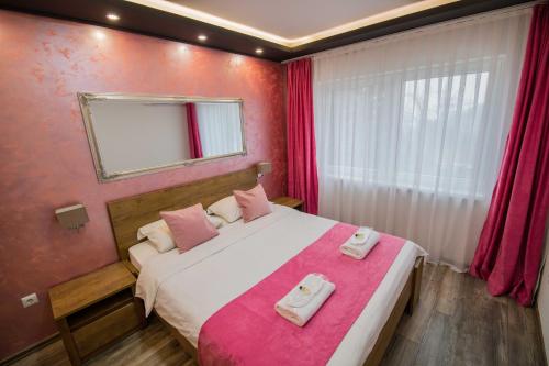 a bedroom with a bed with two towels on it at Villa Panorama in Sarajevo