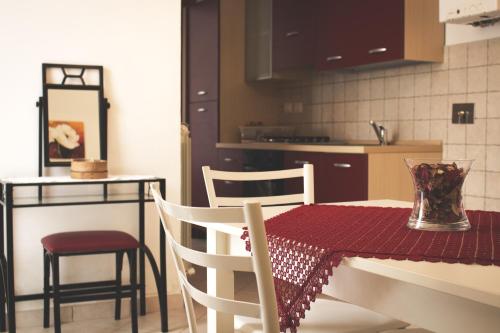 a kitchen with a table with a red table cloth on it at Residence Terra Dei Santi Country House in Spello