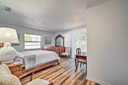 Schlafzimmer mit einem Bett, einem Schreibtisch und einem Fenster in der Unterkunft Dog-Friendly Home, 10 Mi to Downtown Ocala in Ocala