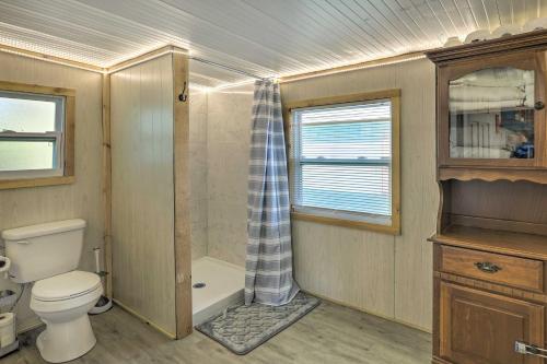 a small bathroom with a toilet and a shower at Pet-Friendly Cocoa Home with Covered Porch! in Cocoa