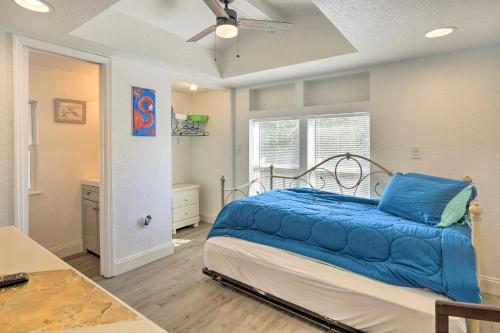 a bedroom with a bed with a blue blanket on it at Pet-Friendly Cocoa Home with Covered Porch! in Cocoa