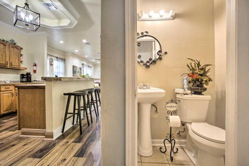 a bathroom with a sink and a toilet and a counter at Central New Orleans Apt with Updated Interior in New Orleans