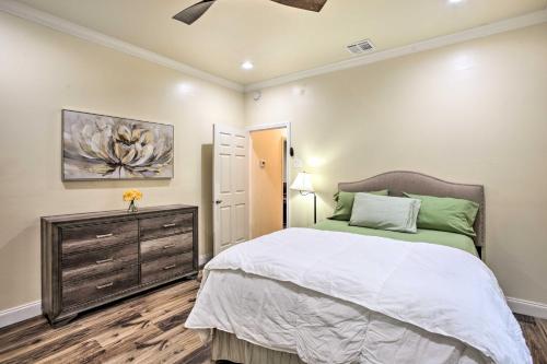 a bedroom with a bed and a dresser in it at Central New Orleans Apt with Updated Interior in New Orleans