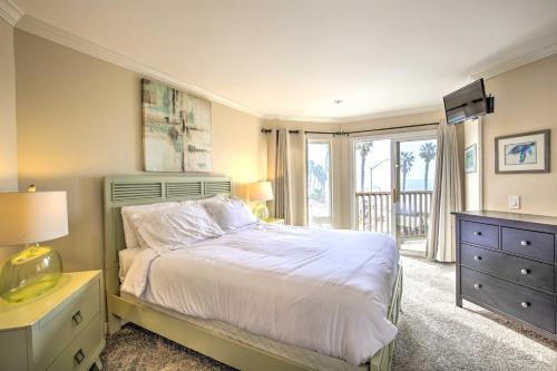 a bedroom with a large bed and a window at Oceanfront Condo, Walk to Pacific Beach! in San Diego