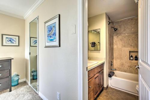a bathroom with a sink and a tub and a toilet at Oceanfront Condo, Walk to Pacific Beach! in San Diego