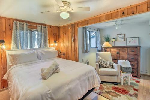 a bedroom with a large white bed and a chair at Near Fool Hollow Lake and Trails Family Cabin in Show Low